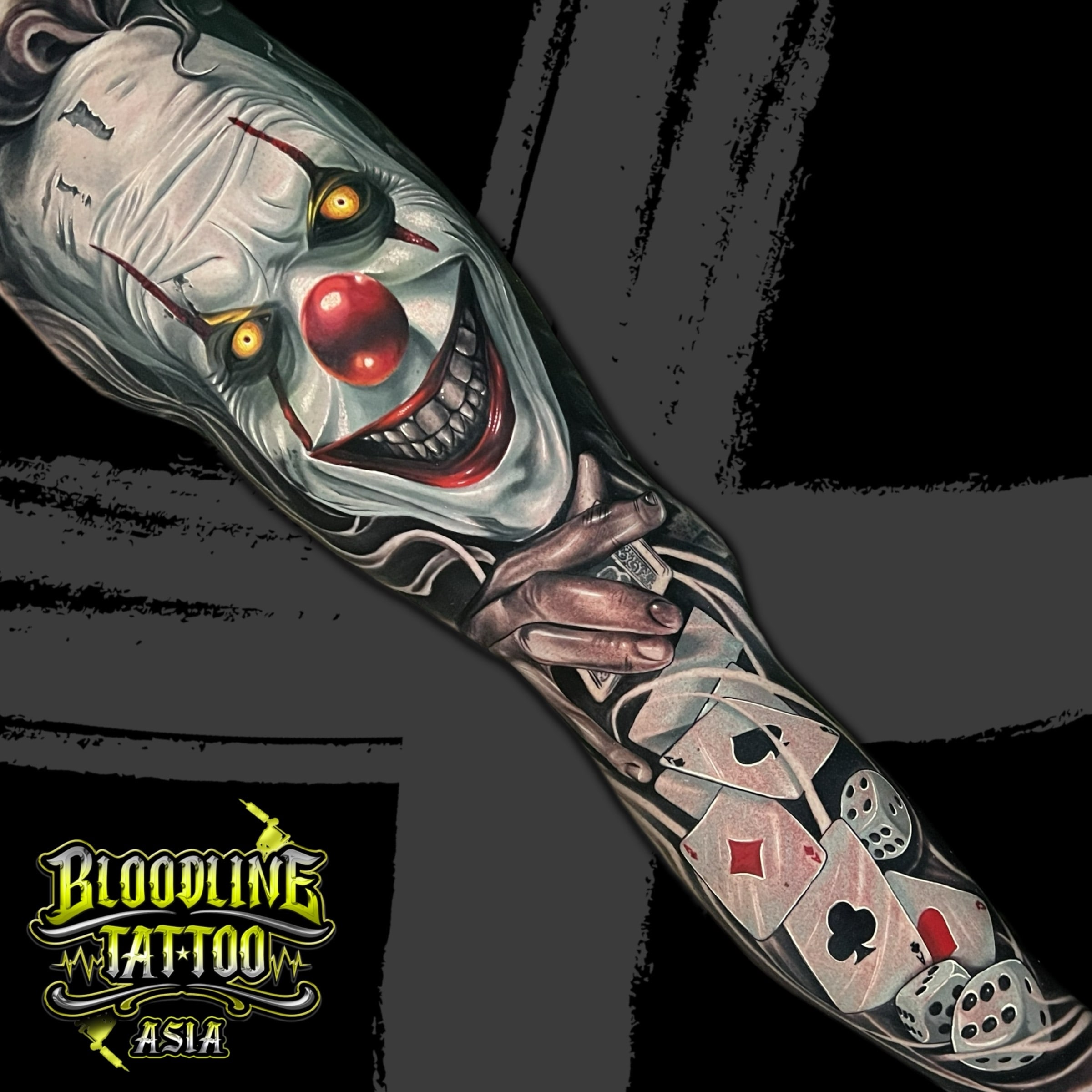 Colour Pennywise clown full sleeve tattoo with playing cards and dice on the arm at Bloodline Tattoo Bali.