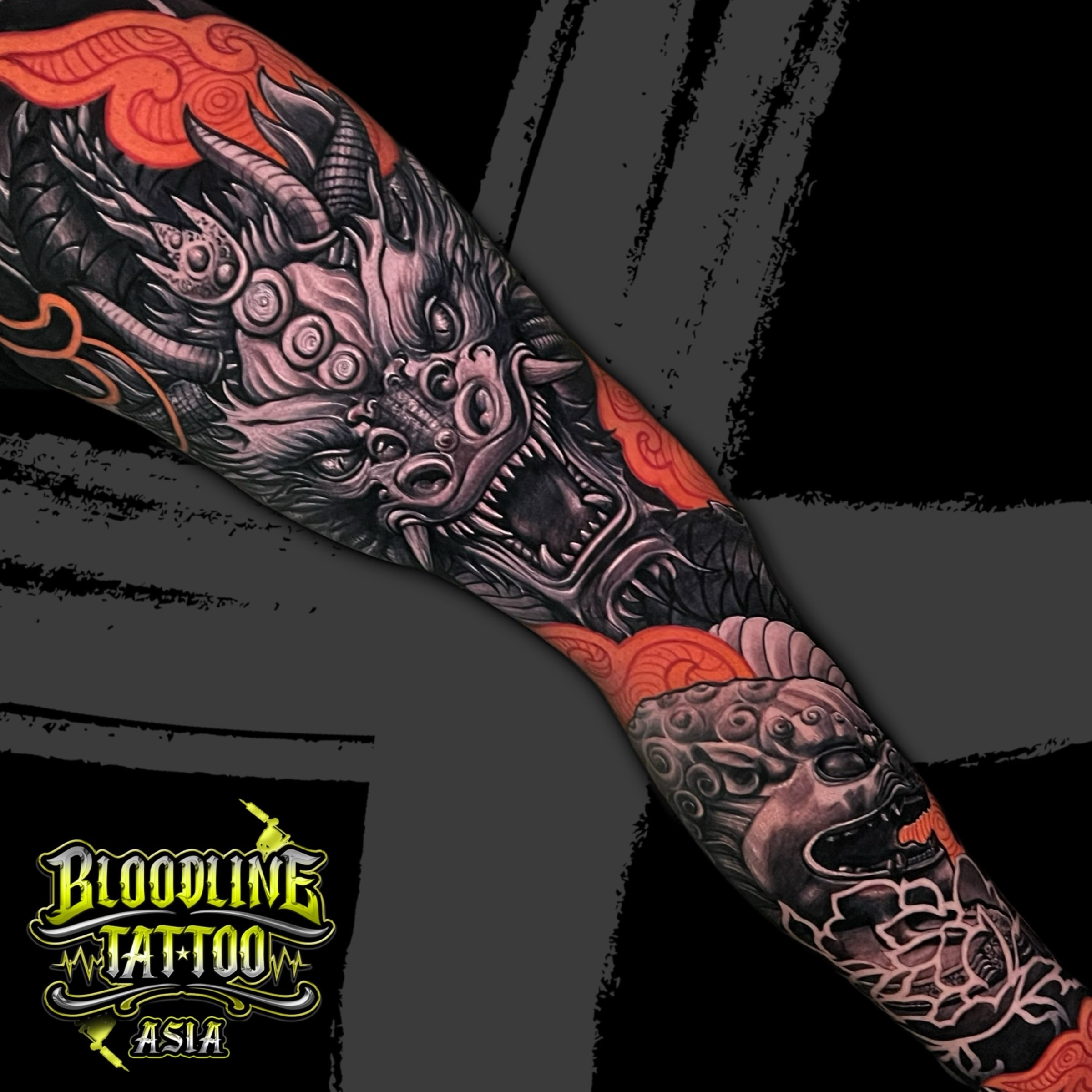 Colour Japanese full arm sleeve tattoo with a dragon head, Fu dog, and orange swirling clouds at Bloodline Tattoo Bali.
